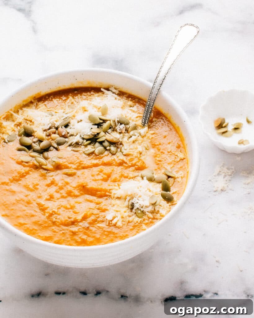 Spiced Golden Squash Soup 2 A bowl of creamy Autumn Squash Soup garnished with fresh herbs, perfect for a cozy fall day.