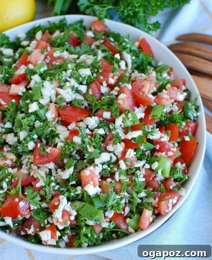 Riced Cauliflower Tabbouleh 2 Cauliflower Tabbouleh in a bowl, showcasing its fresh ingredients and vibrant colors.