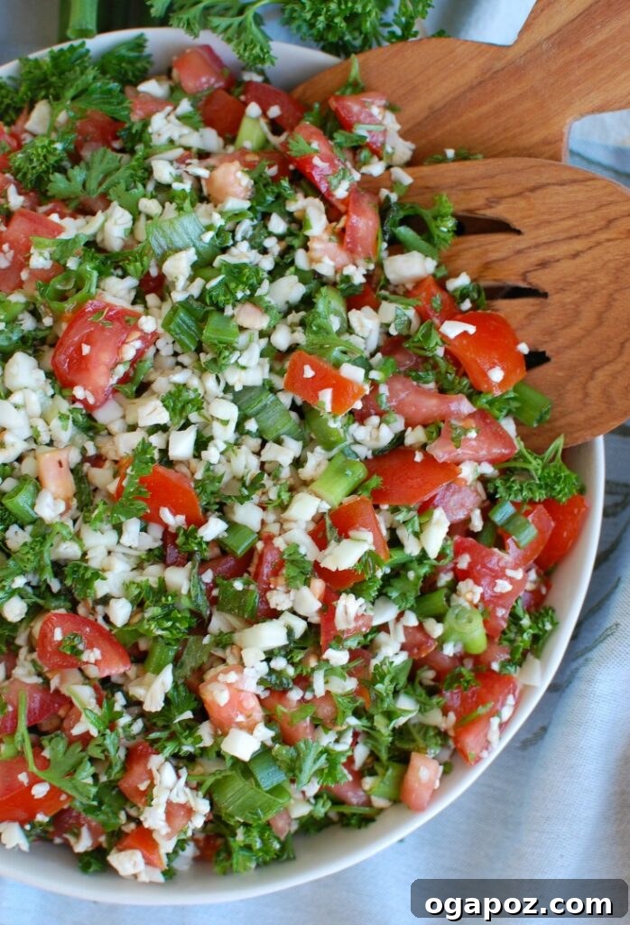 Riced Cauliflower Tabbouleh 3 Fresh ingredients laid out for Cauliflower Tabbouleh, including cauliflower, herbs, and tomatoes.