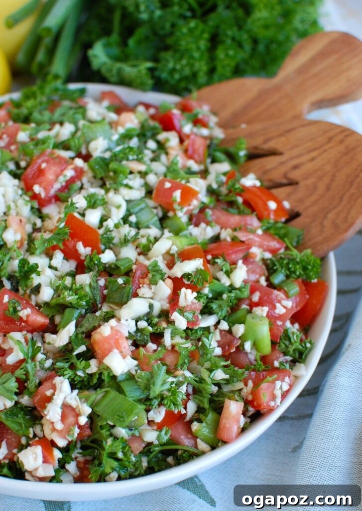Riced Cauliflower Tabbouleh 4 Cauliflower Tabbouleh being served with a wooden spoon, ready to enjoy.