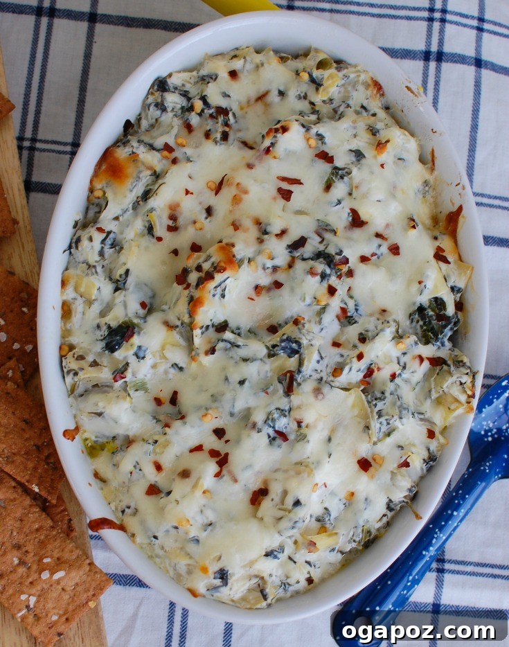 Zesty Lemon Artichoke Spinach Dip 3 Creamy Lemon Spinach Artichoke Dip in a white baking dish, fresh out of the oven