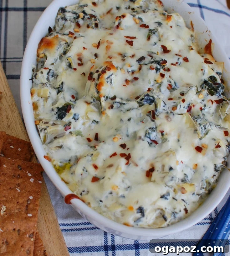 Zesty Lemon Artichoke Spinach Dip 5 Lemon Spinach Artichoke Dip in a serving bowl, garnished and ready for a party