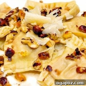Butternut Squash and Mascarpone Ravioli with Hazelnut Brown Butter, served on a white plate