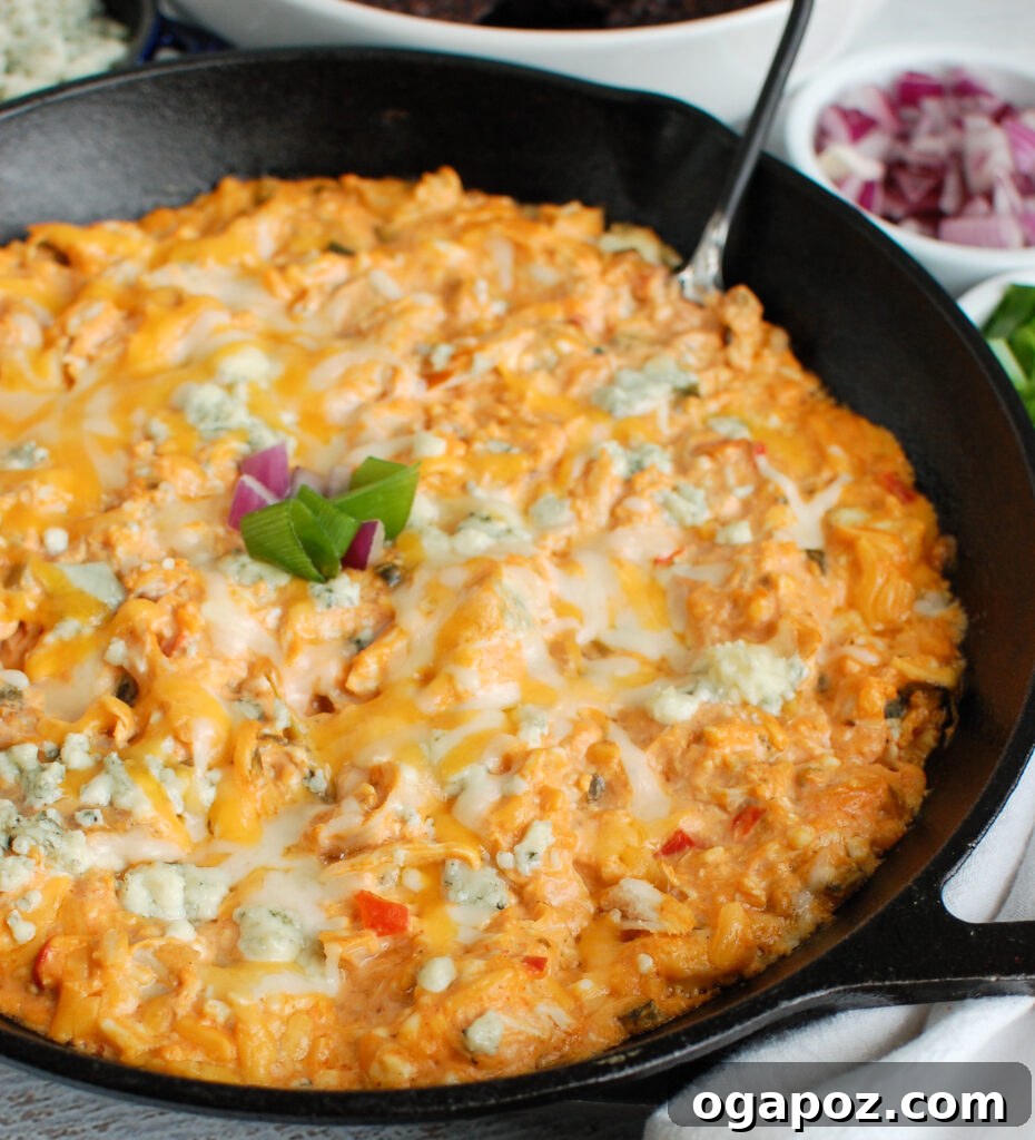 Ultimate Buffalo Chicken Queso 4 Buffalo Chicken Queso Cheese Dip in a black skillet, ready to serve