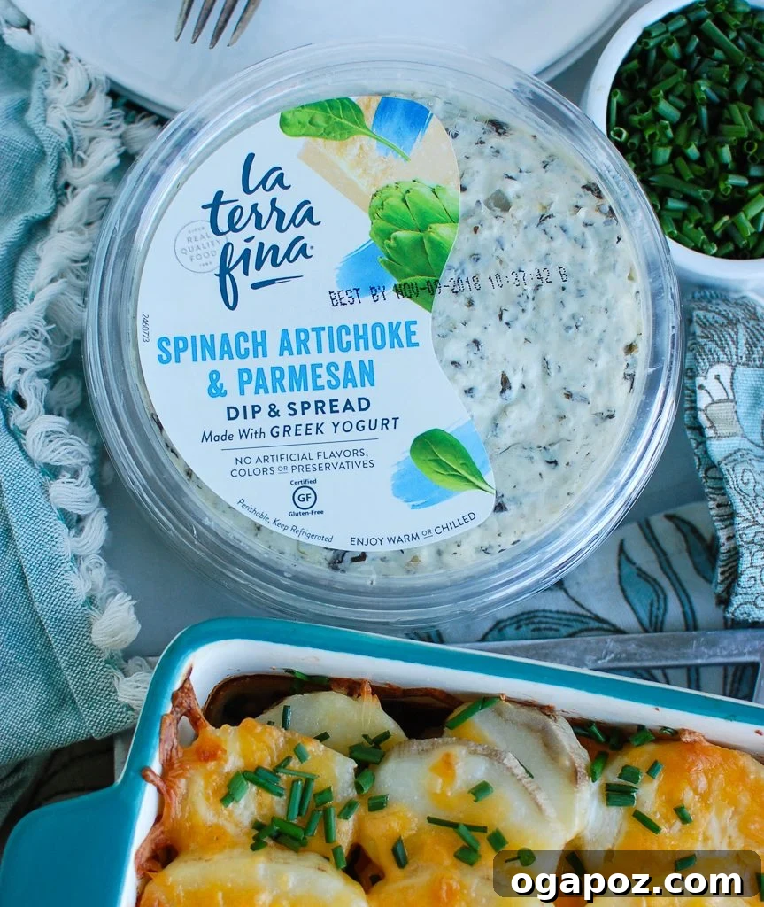 Creamy Spinach Artichoke Potato Gratin 4 A tub of La Terra Fina Spinach Artichoke & Parmesan Greek Yogurt Dip, ready to be used in the recipe.