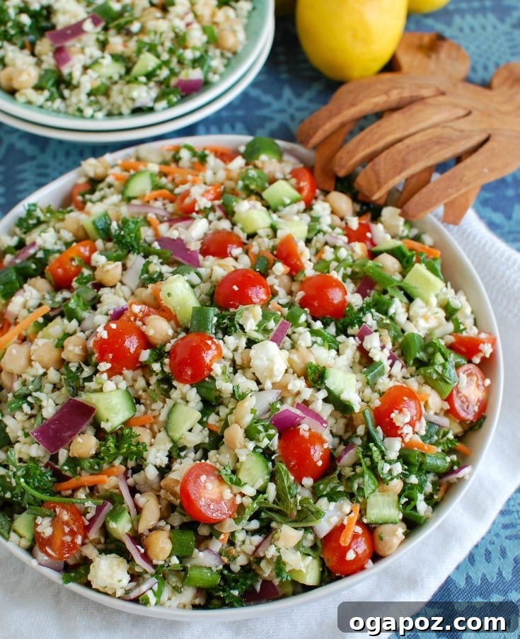 Close-up of Mediterranean Chickpea Cauliflower Salad, featuring bright red tomatoes and fresh herbs.