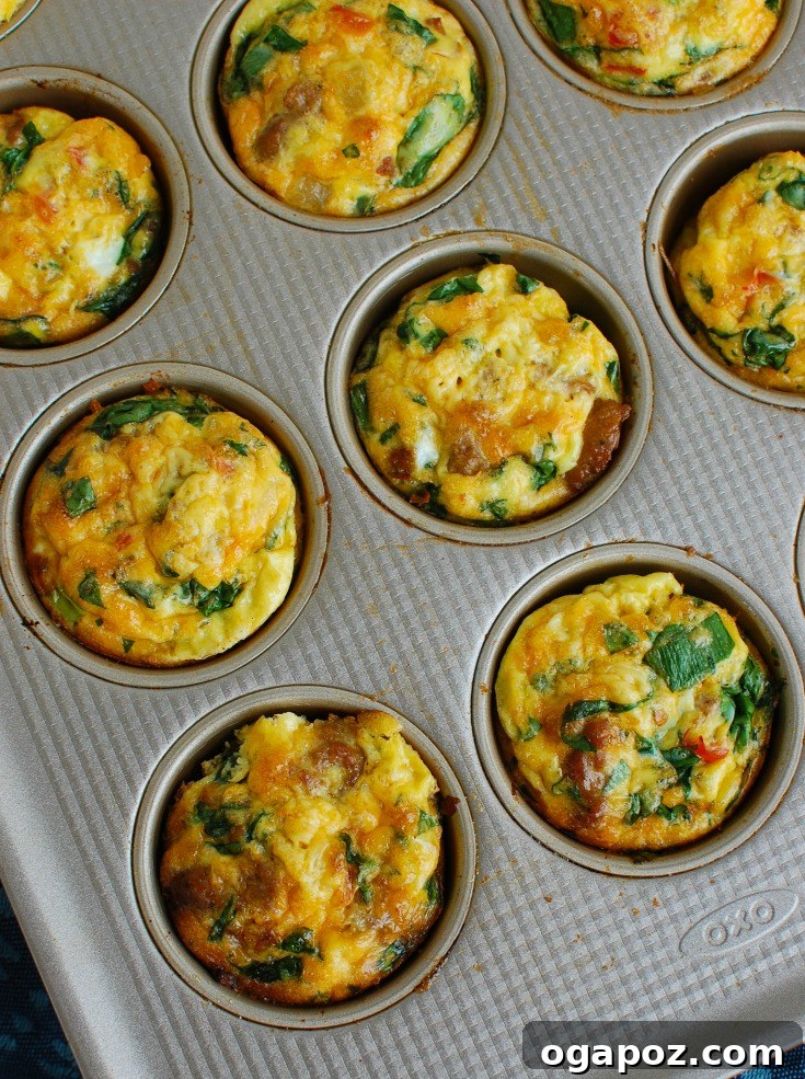 Southwest Turkey Sausage Sunrise Bites 5 Freshly baked Southwestern Turkey Sausage Egg Cups cooling in a muffin tin, ready to be removed and served