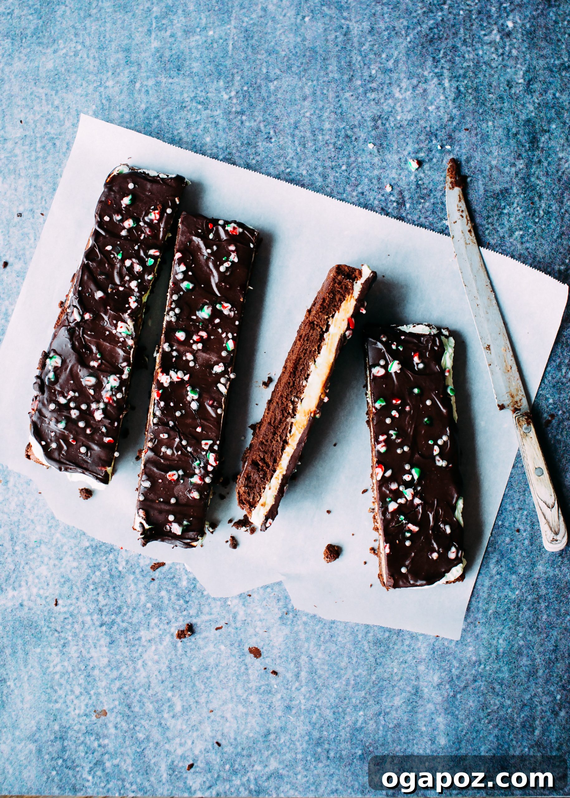 Chocolate Mint Brownie Triple Threat 4 Individual mint chocolate brownies, cut into neat squares, displaying layers of brownie, frosting, ganache, and candy cane topping