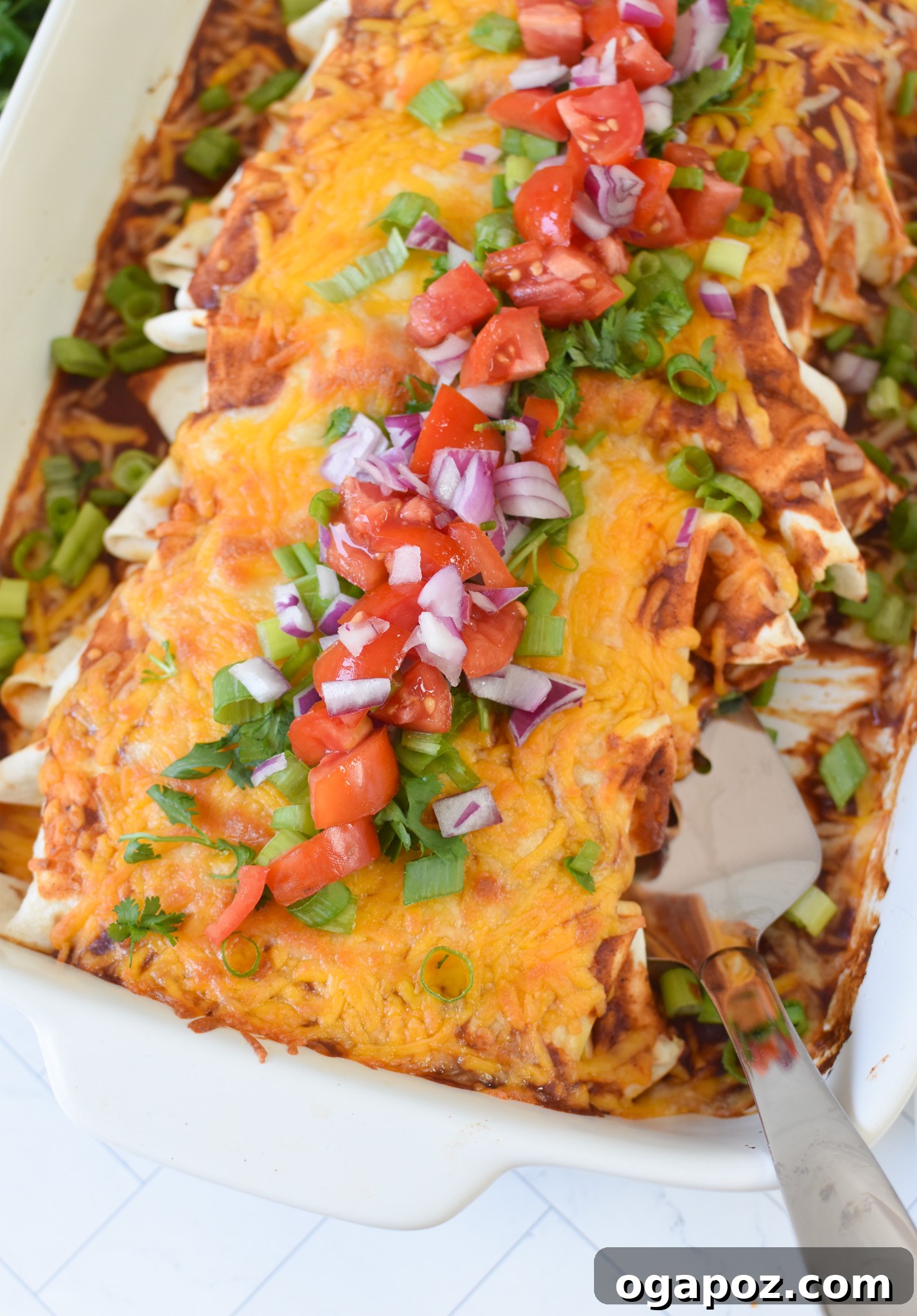 Quick & Hearty Beef Enchiladas 2 Hearty Beef Enchiladas baked in a pan, ready to serve.
