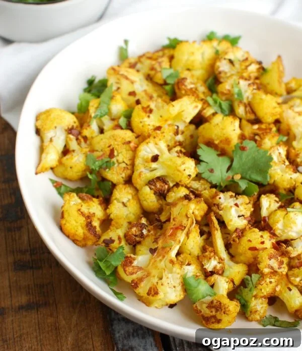 Golden Turmeric Roasted Cauliflower 5 Serving bowl of Turmeric Roasted Cauliflower with a scattering of fresh cilantro.