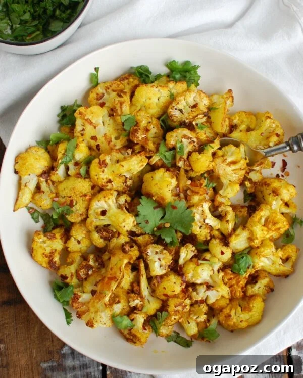 Golden Turmeric Roasted Cauliflower 6 Overhead shot of Turmeric Roasted Cauliflower, beautifully browned and seasoned, on a baking sheet.