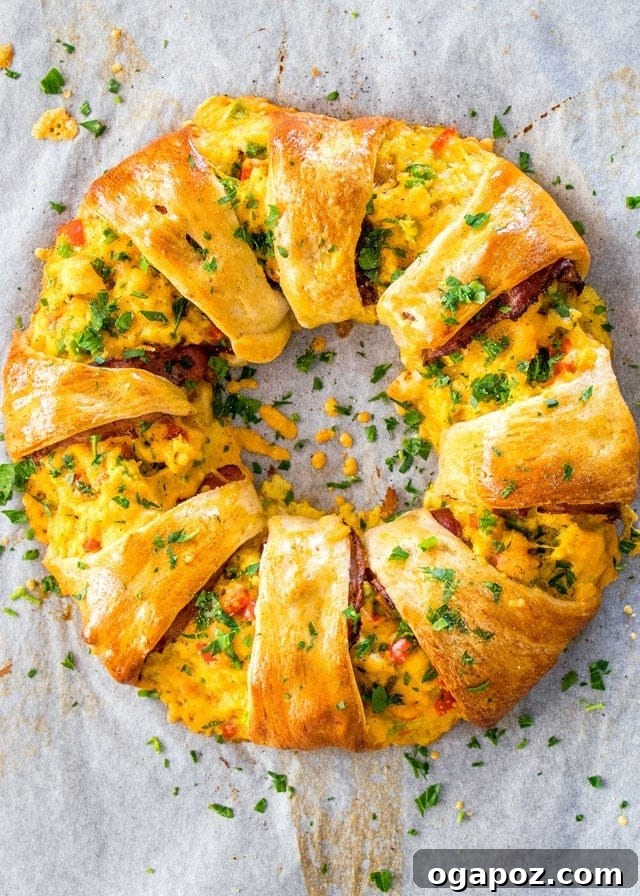 A beautifully braided Crescent Breakfast Ring, golden-brown and filled with savory ingredients, making an impressive centerpiece for breakfast or brunch.