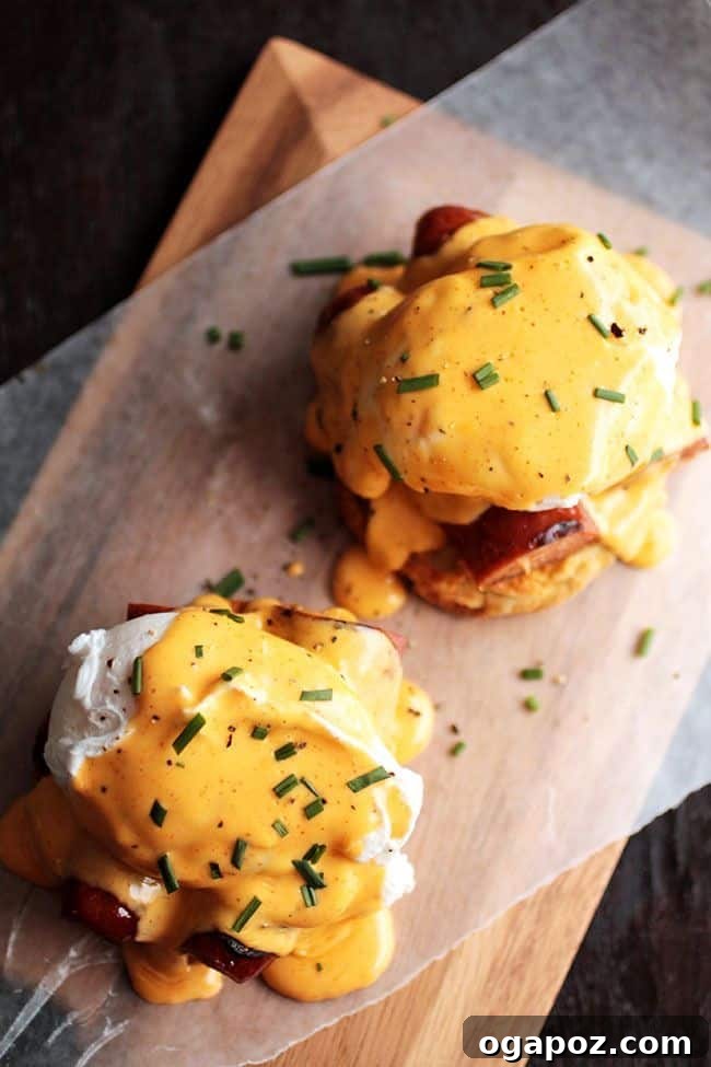 A vibrant plate of Cajun Eggs Benedict, featuring perfectly poached eggs atop savory elements, drizzled with a spicy hollandaise sauce, ready to be enjoyed.