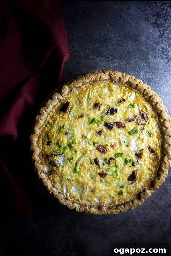 A magnificent Cheesy Shrimp and Sausage Quiche, baked to a golden perfection, showcasing a delightful combination of seafood and savory meat in a rich egg custard.