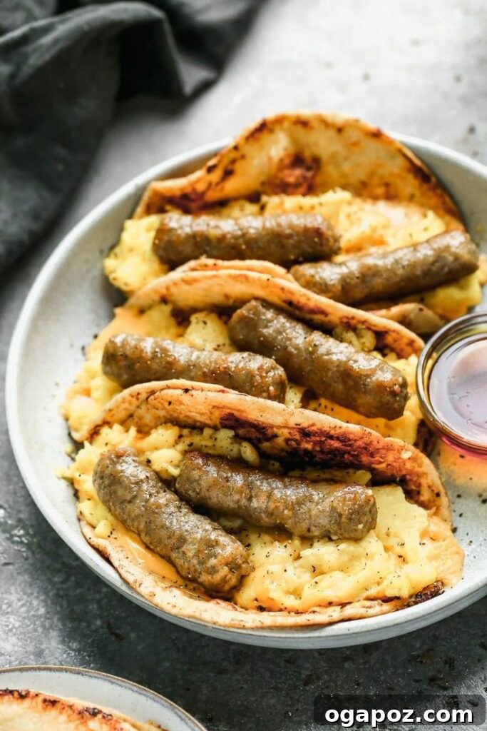 Creative French Toast Sausage and Egg Tacos, featuring sausages wrapped in golden French toast, a unique and fun sweet and savory breakfast combination.