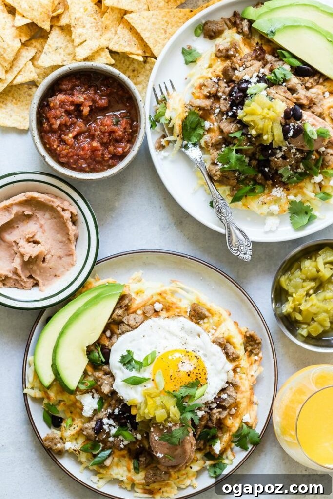 Crispy Waffle Iron Hash Browns, generously topped with melted sharp cheddar cheese, refried beans, cilantro, and green onions, served with creamy avocado.