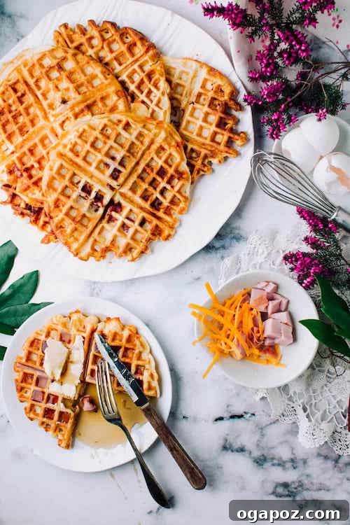 Savory Ham and Cheese Buttermilk Waffles, golden and crispy, drizzled with maple syrup for a perfect sweet and salty combination.