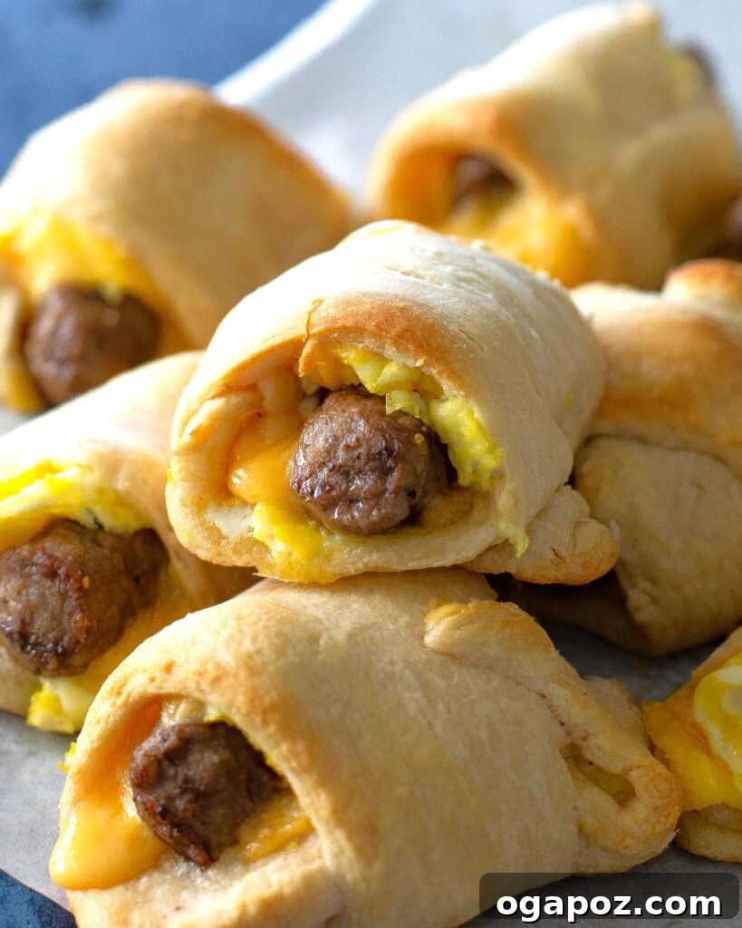 Elegant Sausage and Egg Roll-ups, beautifully arranged on a wooden board, with a flaky pastry crust and a savory filling, perfect for entertaining.