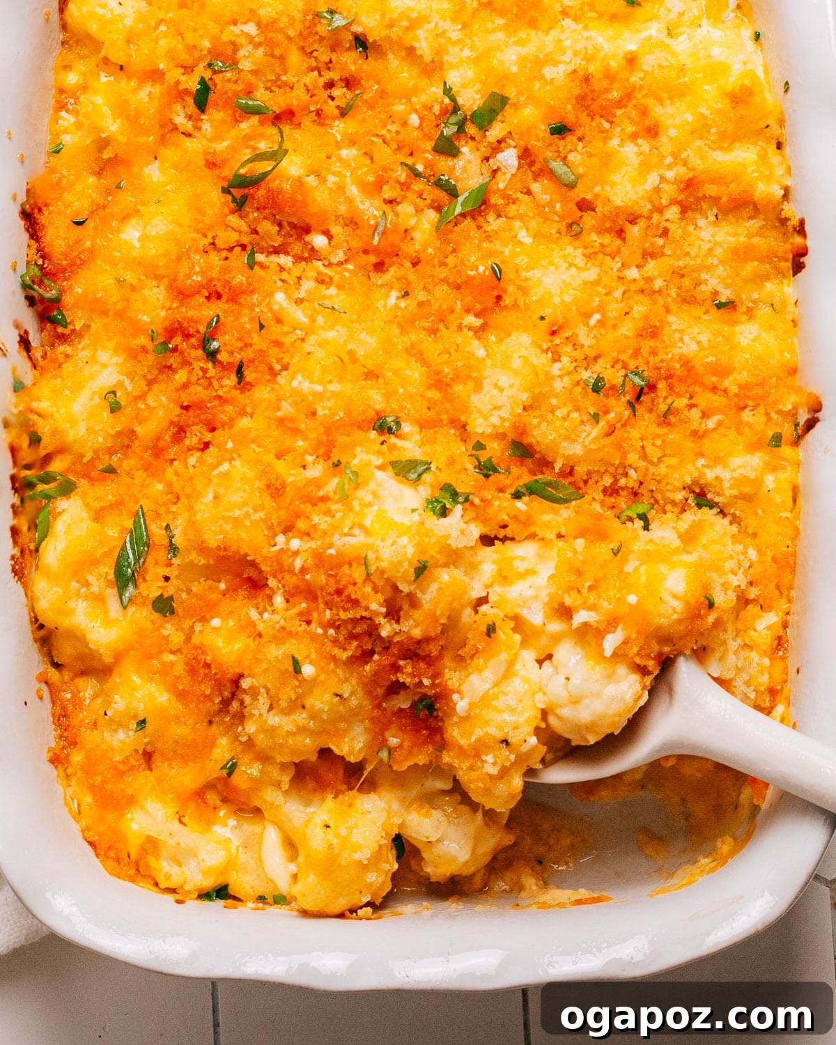 Effortless Healthy Sides for Meatloaf 35 Delicious Choices 4 A healthy cauliflower casserole, rich and cheesy, served in a baking dish with a spoon, highlighting its golden crumb topping.