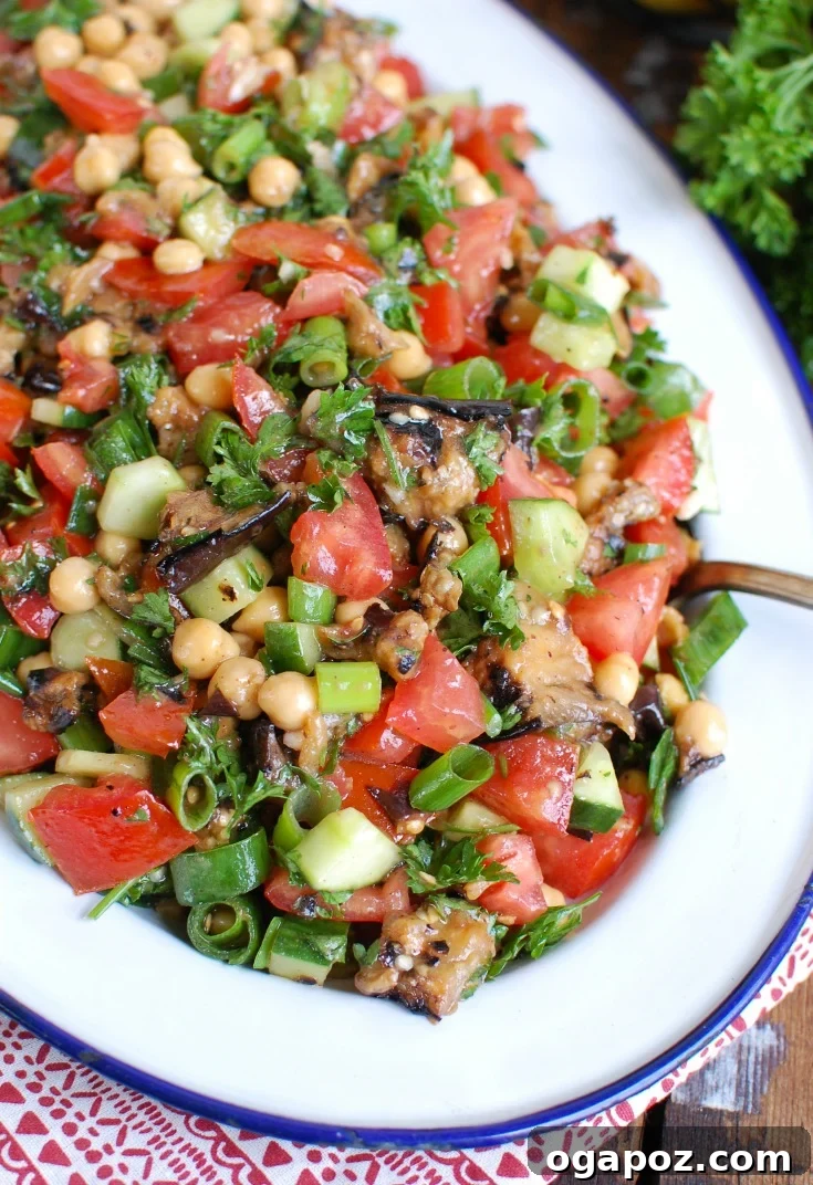 Zesty Mediterranean Eggplant Chickpea Delight 5 Mediterranean Eggplant Chickpea Salad on a white platter, ready to serve.