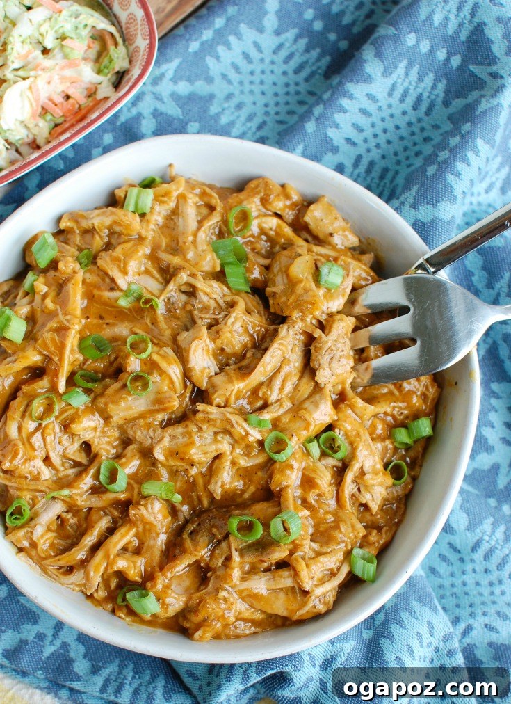 Effortless Slow Cooker Pork Tenderloin 7 Slow Cooker Pork Tenderloin in a bowl with a fork, ready to be served as pulled pork