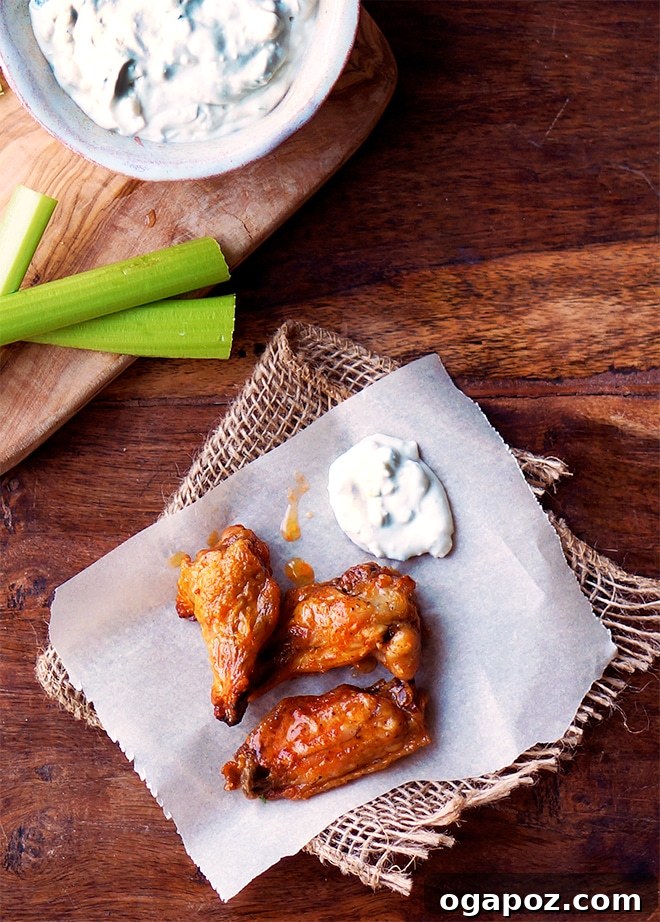 Oven-Crisped Buffalo Wings with Scratch-Made Blue Cheese Dressing 4 crispy oven baked chicken wings with celery sticks and homemade blue cheese