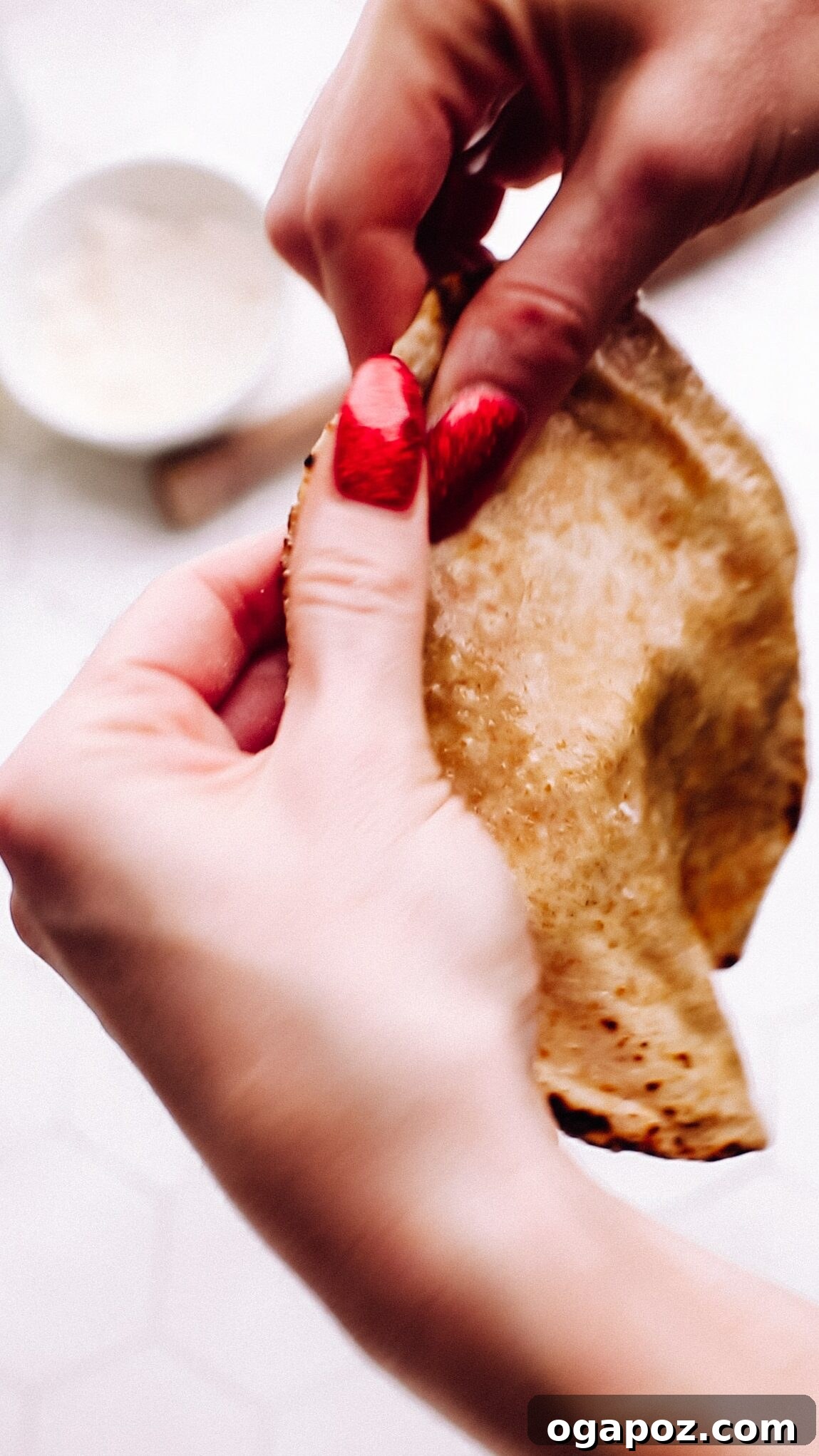 Pillowy Soft Roti A Time Tested Family Favorite 4 Holding soft roti.