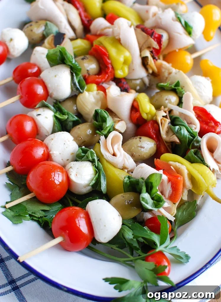 Vibrant Mediterranean Antipasto Skewers arranged on a white plate, showcasing a delightful mix of turkey, olives, and fresh mozzarella.