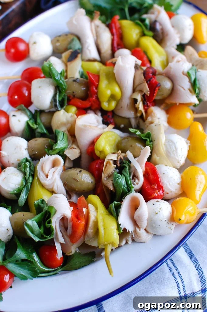 A festive platter of Mediterranean Antipasto Skewers featuring tender Kretschmar Off The Bone turkey breasts, fresh mozzarella, and a colorful assortment of olives and vegetables, ready for serving.