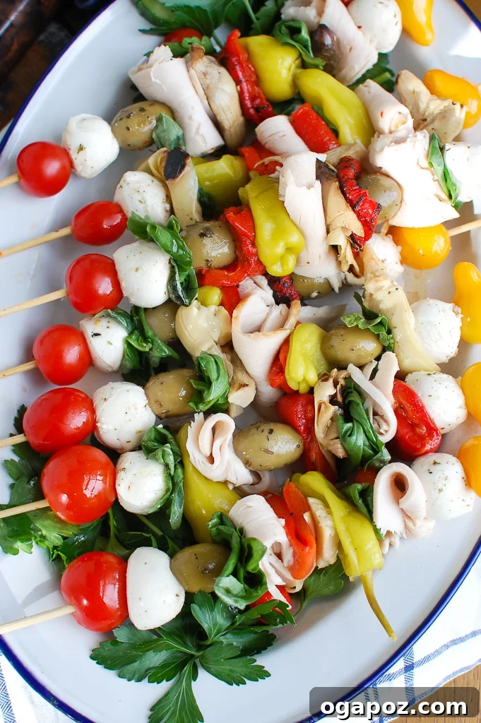 An overhead shot of Mediterranean Antipasto Skewers, beautifully arranged on a white platter, showcasing the fresh, vibrant ingredients.