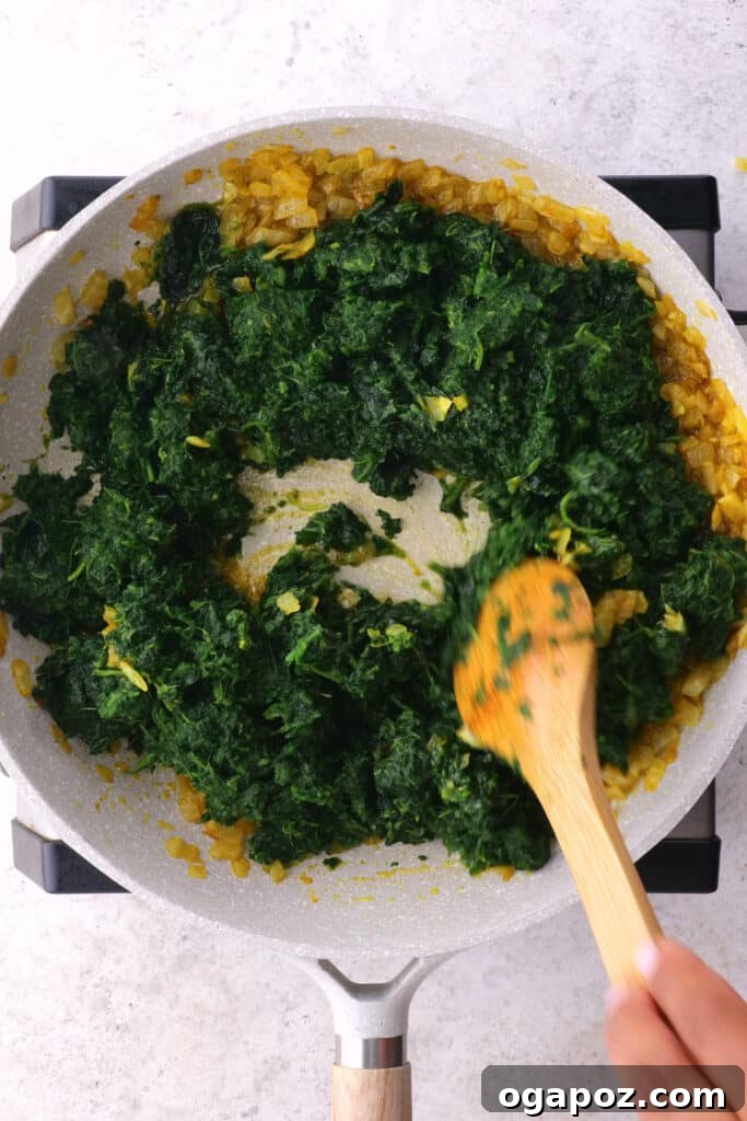 Creamy Indian Spinach and Paneer 5 Stirring spinach into saag paneer.