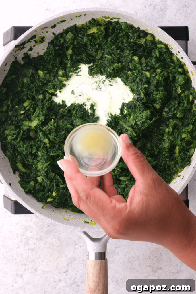 Creamy Indian Spinach and Paneer 6 Adding lemon juice to saag paneer.