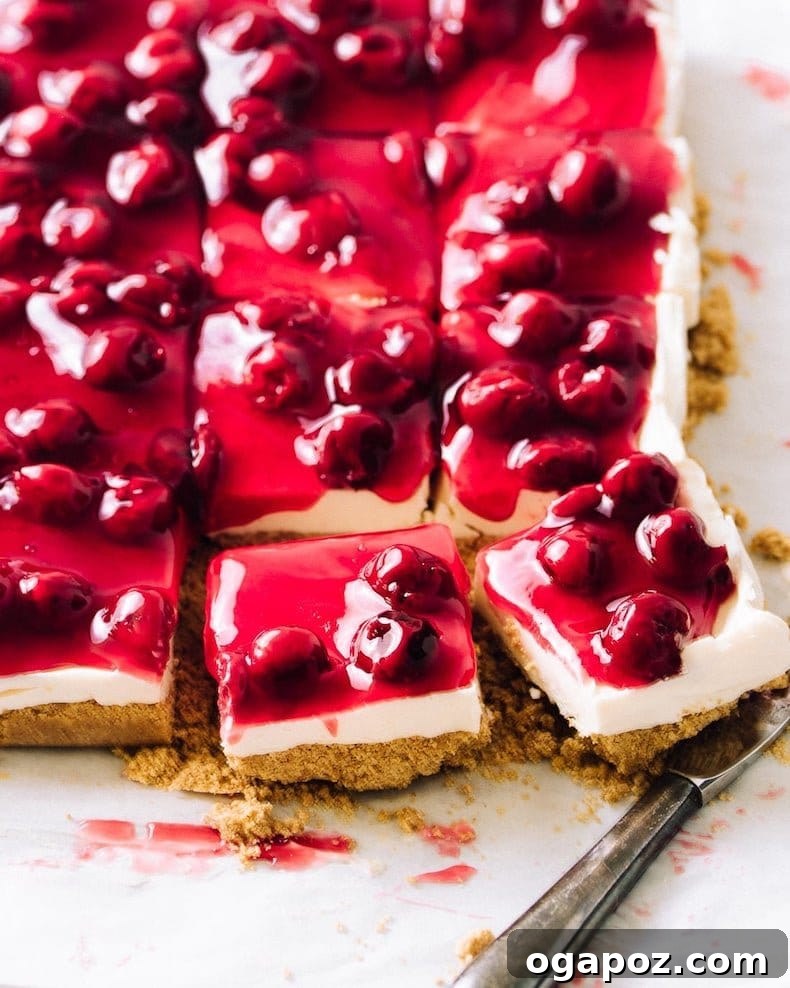 Philadelphia Cheesecake Classic Perfection Pro Insights 18 A tray of cherry cheesecake bars, featuring a crumbly crust and a generous cherry topping.