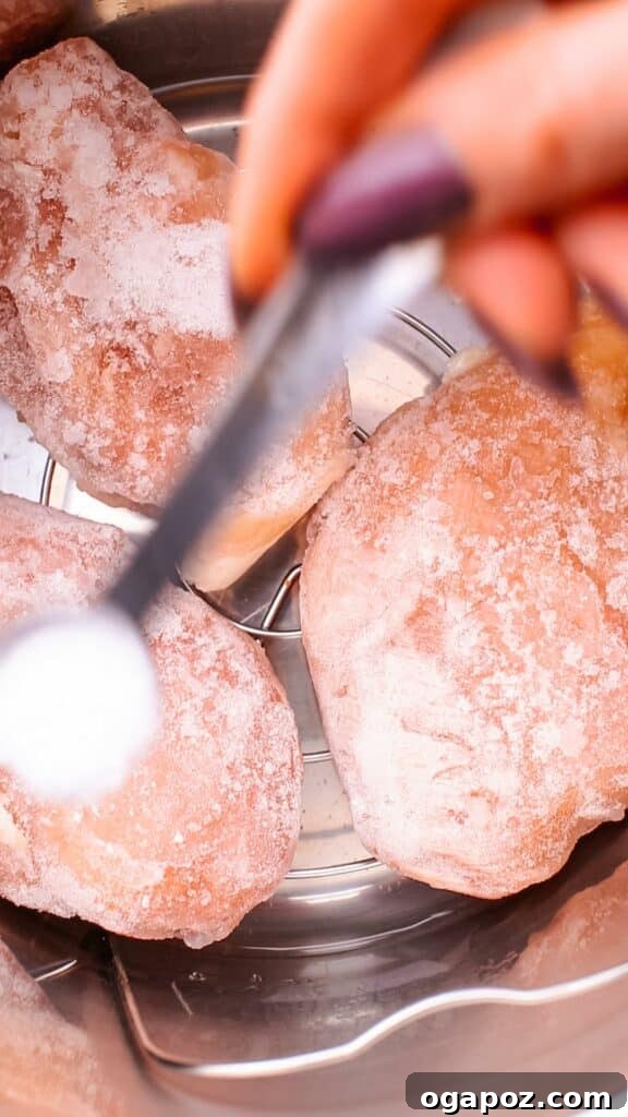 Transform Frozen Chicken into a Juicy Instant Pot Meal 6 Frozen chicken breasts being seasoned.
