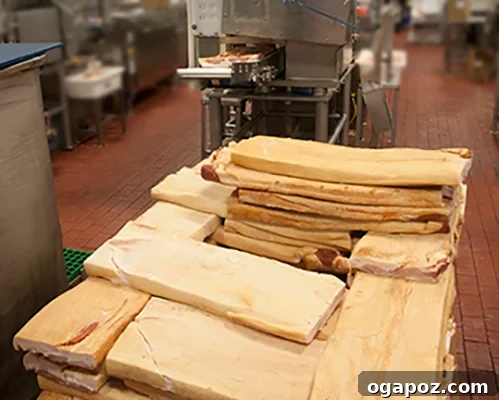 Cheesy Bacon Pizza Poppers 9 Bacon being precisely sliced by machinery for packaging
