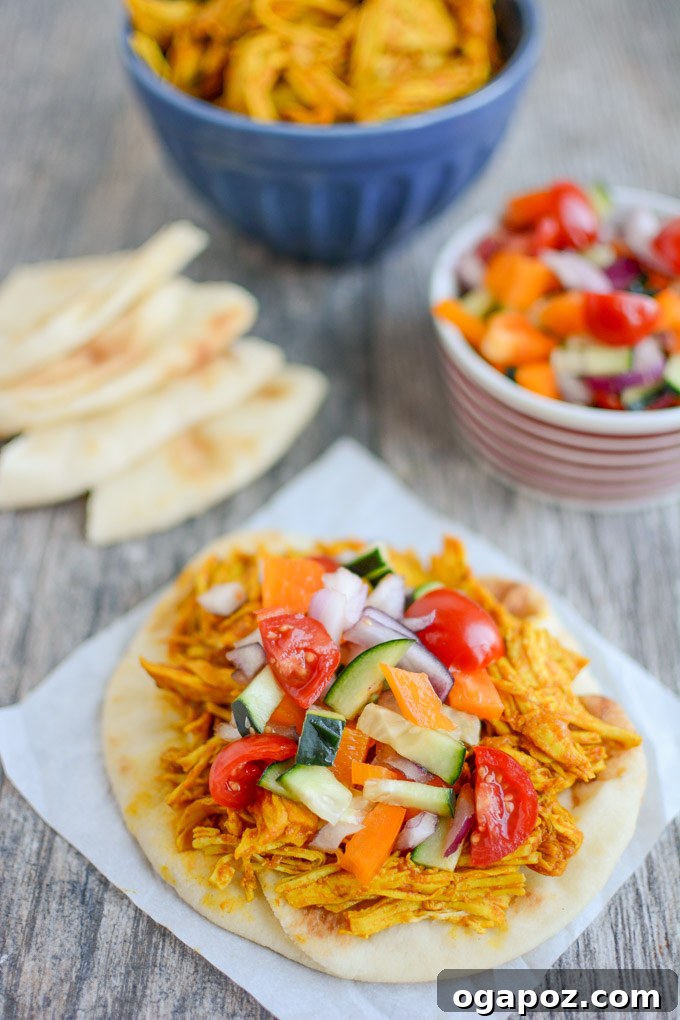 Flavorful Persian pulled chicken, tender and shredded, garnished with fresh herbs, ideal for wraps, rice bowls, or salads.
