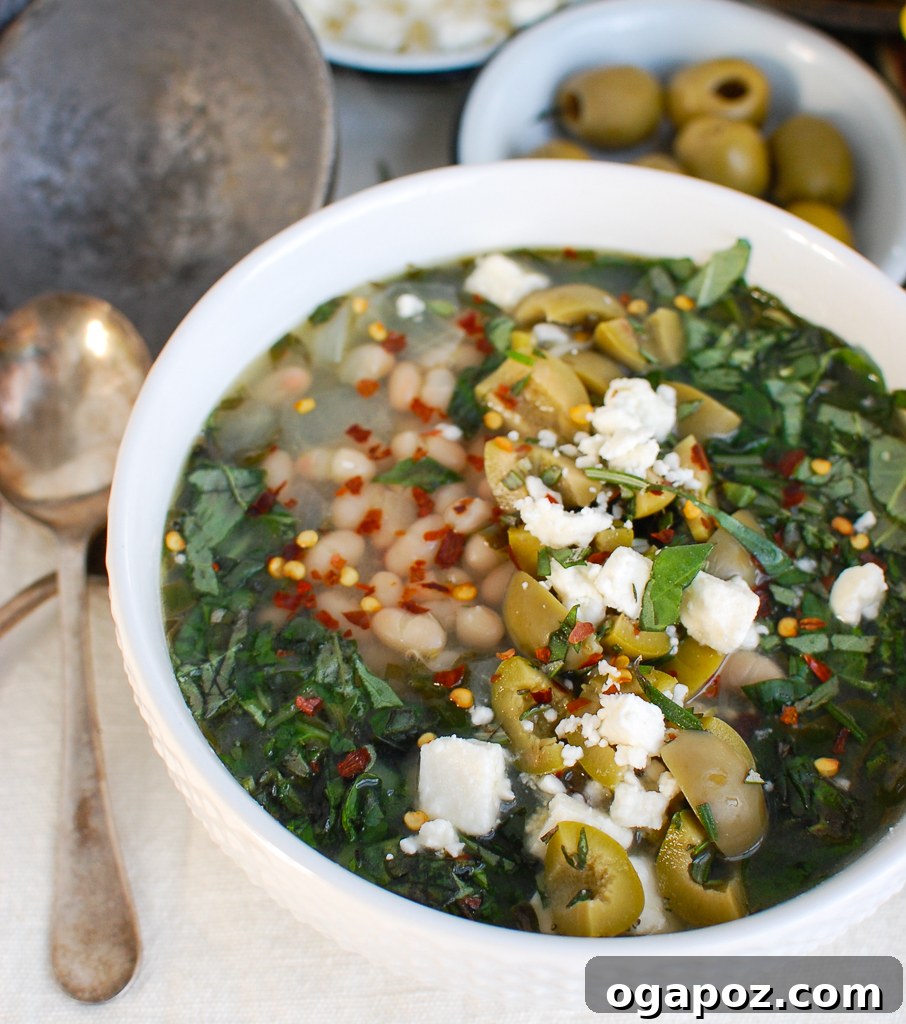 Rustic Mediterranean White Bean Soup 3 A close-up of Mediterranean White Bean Soup garnished with olives and a drizzle of olive oil.