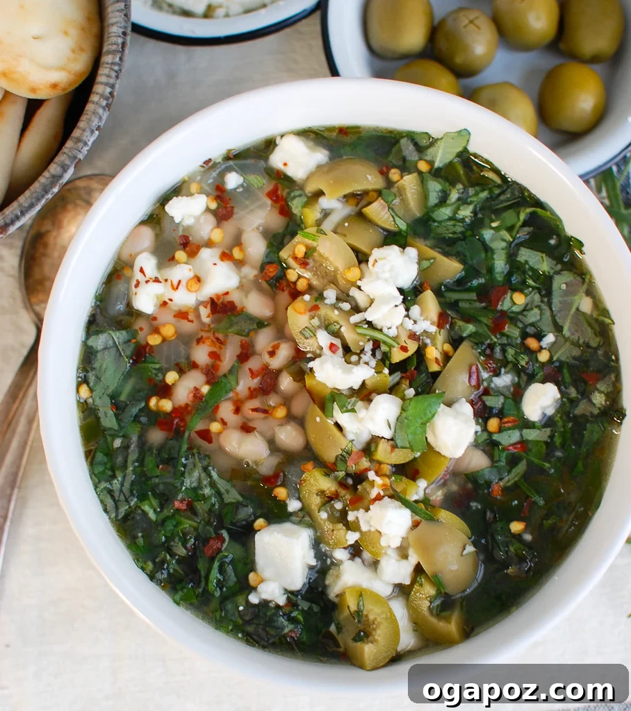 Rustic Mediterranean White Bean Soup 5 A large pot of Mediterranean White Bean Soup simmering, filled with healthy ingredients.