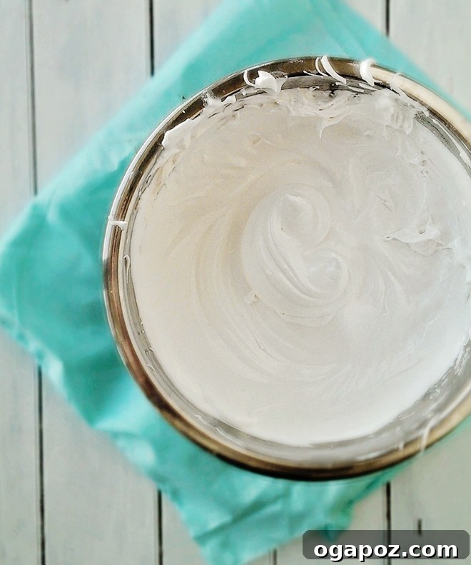 Decadent Caramallow Cupcakes 6 A bowl of creamy, white marshmallow frosting, ready for piping