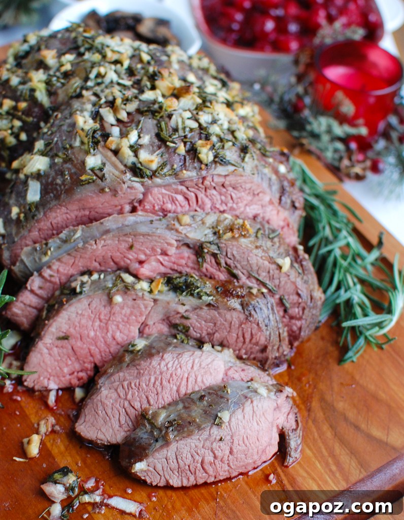 Ultimate Roast Beef Perfection 5 Beautifully sliced roast beef on a cutting board, garnished with fresh herbs, ready for serving.