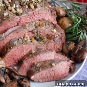 The Ultimate Herb-Crusted Roast Beef on a white platter, ready to be served.