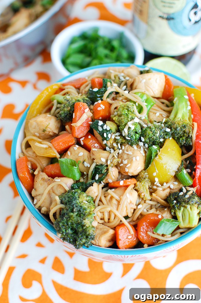 Flavorful Chicken Ramen Stir Fry 2 Easy Chicken Ramen Noodle Stir Fry in a bowl, garnished with green onions and sesame seeds.