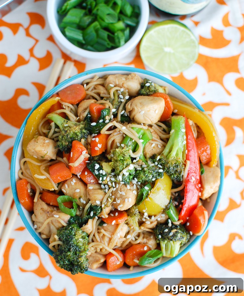 Flavorful Chicken Ramen Stir Fry 3 A serving of Easy Chicken Ramen Noodle Stir Fry in a blue bowl, showcasing the noodles, chicken, and colorful vegetables.