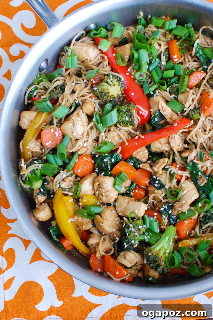 Flavorful Chicken Ramen Stir Fry 4 Easy Chicken Ramen Noodle Stir Fry being cooked in a large skillet, showing chicken and vegetables