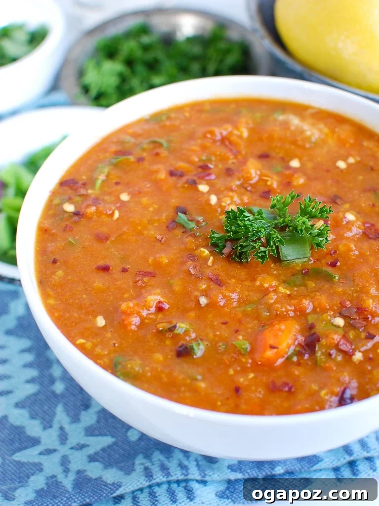 A warm bowl of Slow Cooker Lentil Soup, garnished with fresh herbs, perfect for a cozy meal.