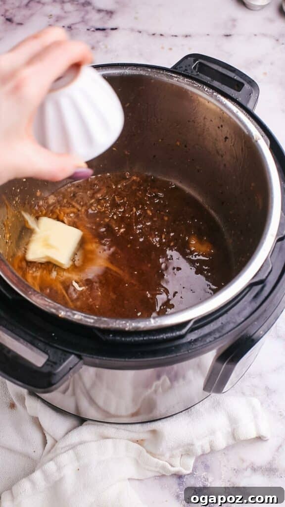 Instant Pot Steak: Fork-Tender Perfection with Savory Pan Sauce 11 Adding butter to the pan sauce in the Instant Pot.