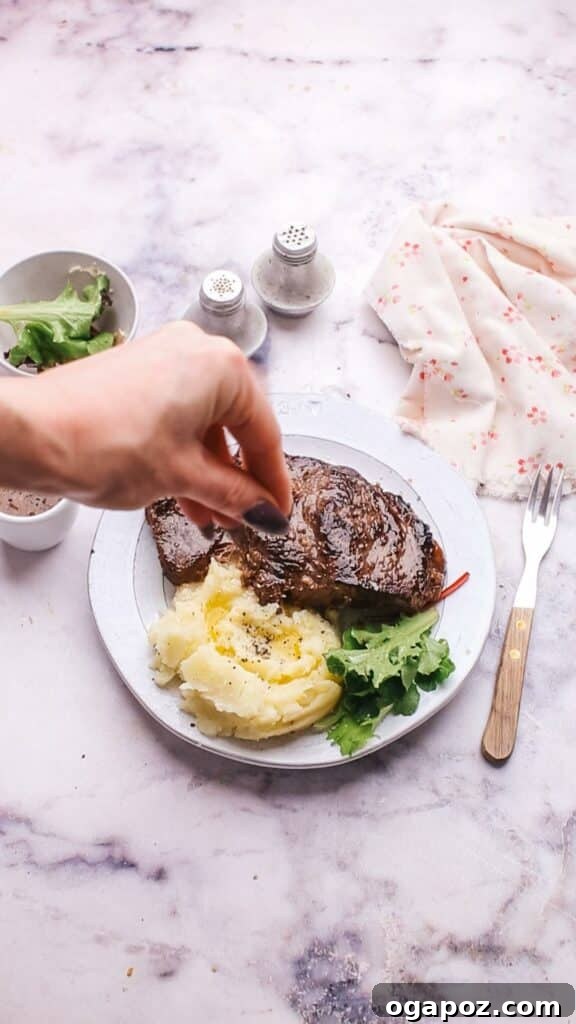 Instant Pot Steak: Fork-Tender Perfection with Savory Pan Sauce 14 Garnishing Instant Pot Steak with sauce and fresh herbs.
