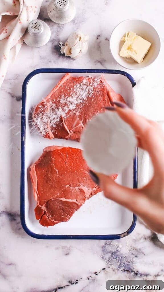 Instant Pot Steak: Fork-Tender Perfection with Savory Pan Sauce 4 Adding salt and pepper to raw steak.
