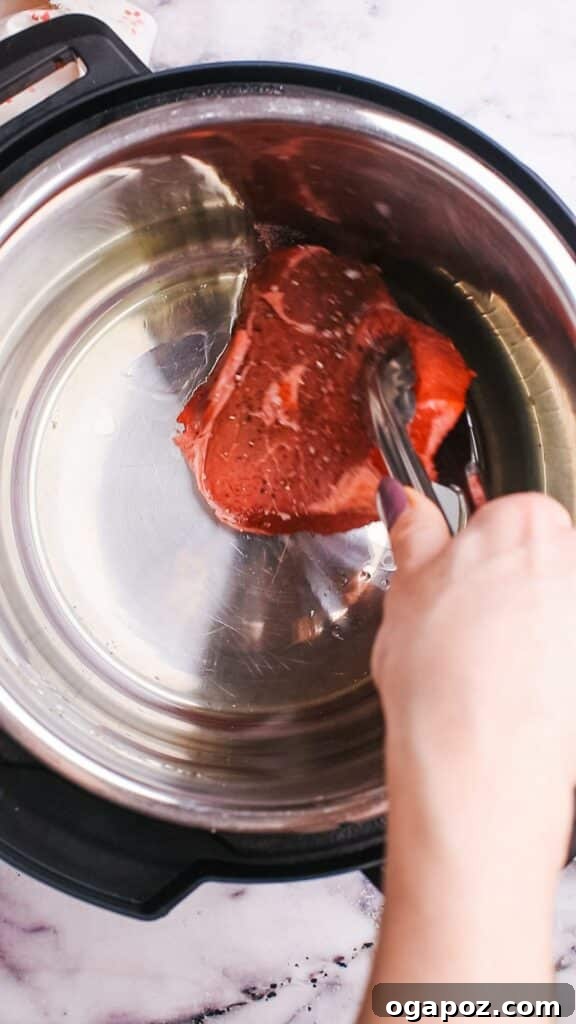 Instant Pot Steak: Fork-Tender Perfection with Savory Pan Sauce 5 Searing steak in a pan.