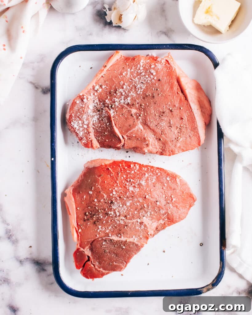 Instant Pot Steak: Fork-Tender Perfection with Savory Pan Sauce 6 Raw steak seasoned with salt and pepper.